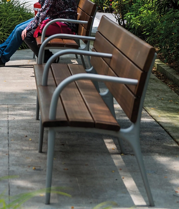 Nahaufnahme zweier Bänke in einem Stadtpark.