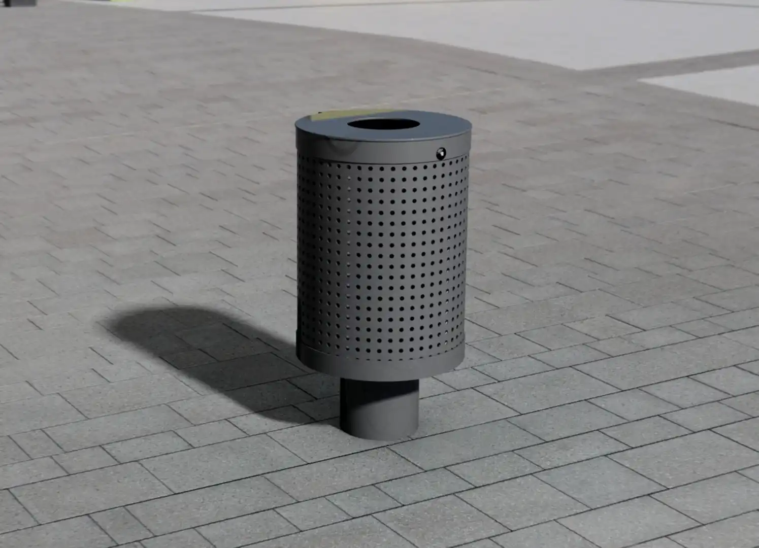 Moderner, grauer Abfallbehälter mit einem perforierten Design steht auf einem gepflasterten Boden.