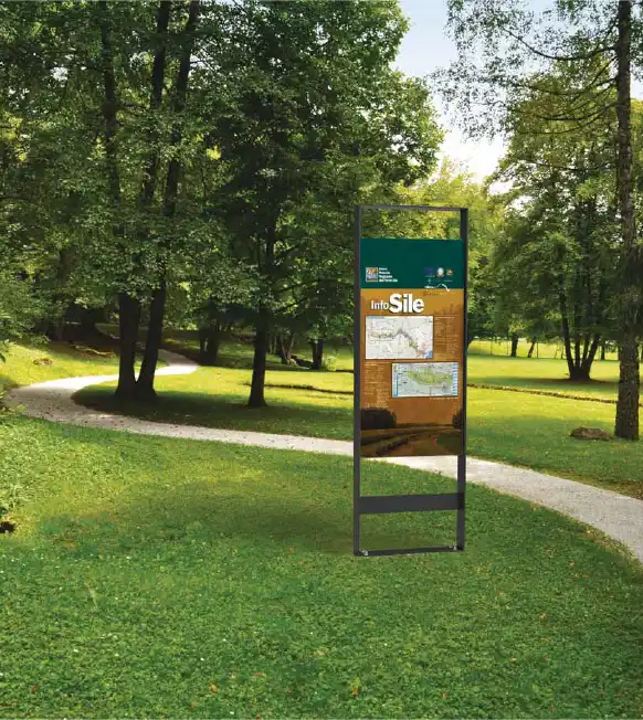 Alt-Text: Informationsschild in einem Park, umgeben von Bäumen und einem Fußweg.